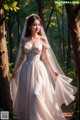 A woman in a wedding dress standing in the woods.