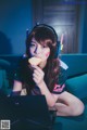 A woman sitting on a couch eating a piece of bread.