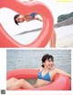 A woman in a blue bikini laying on an inflatable ring.