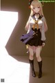 Anime girl in a sailor outfit standing in front of a window.